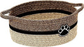 Light beige handmade cotton rope woven storage basket with handle on a wooden surface.
