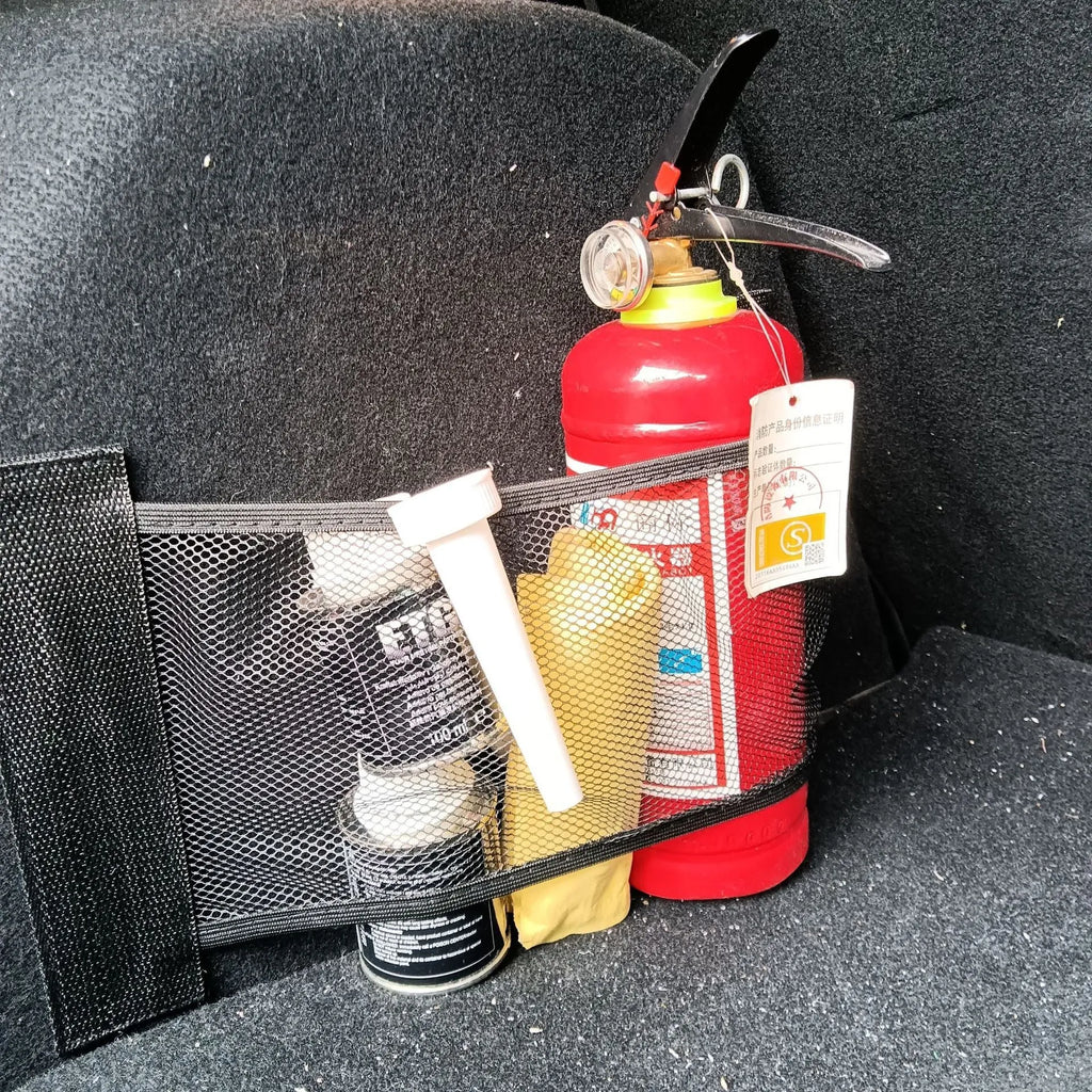 Elasticated grey polyester storage net stretched across a car boot, holding assorted items.