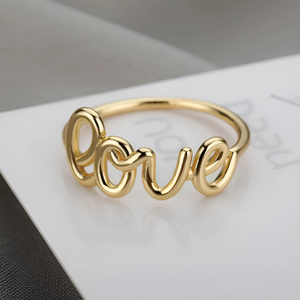Small unisex copper LOVE ring with engraved text in gold finish for couples