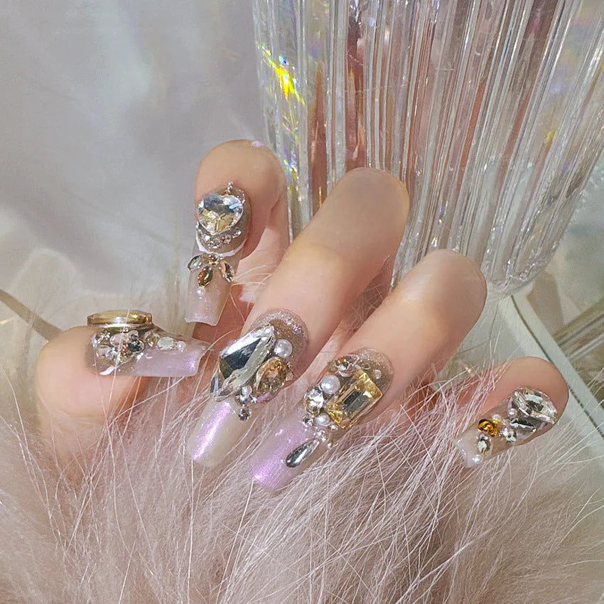 False nail patches with rhinestone embellishments in S number sizing on card paper packaging