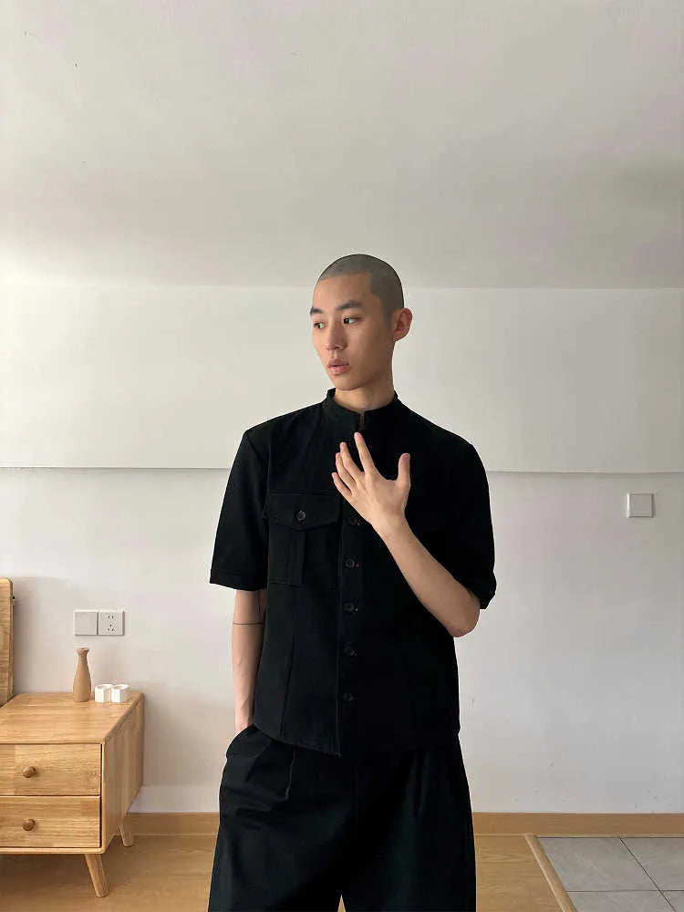 Black handmade half-sleeve hunting shirt with a shirt collar and loose fit on a mannequin.