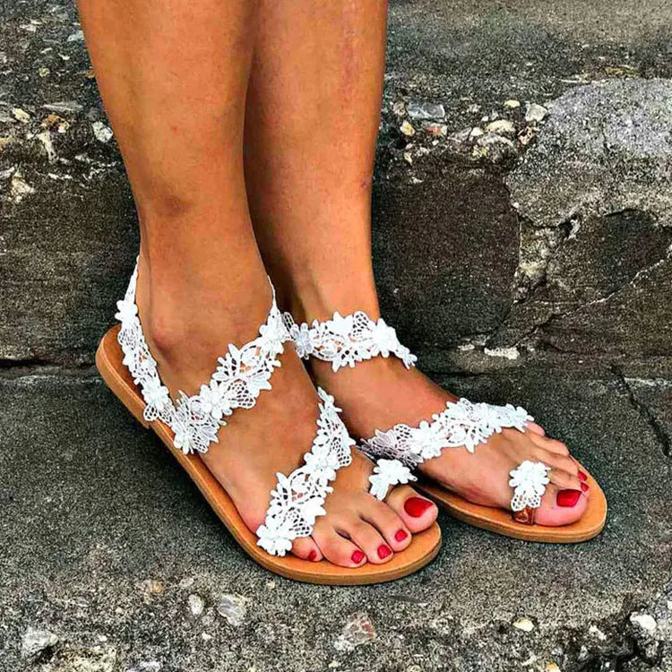 White plus size flat sandals with rhinestone flower patterns and slip-on sleeve design