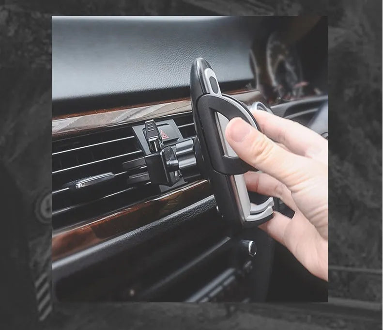 Black plastic car air vent mobile phone holder mounted on vehicle dashboard