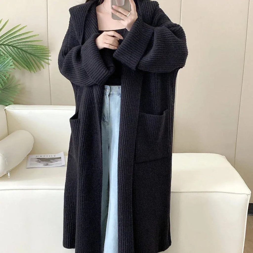 Loose hooded acrylic cardigan coat with extended length and raglan sleeves