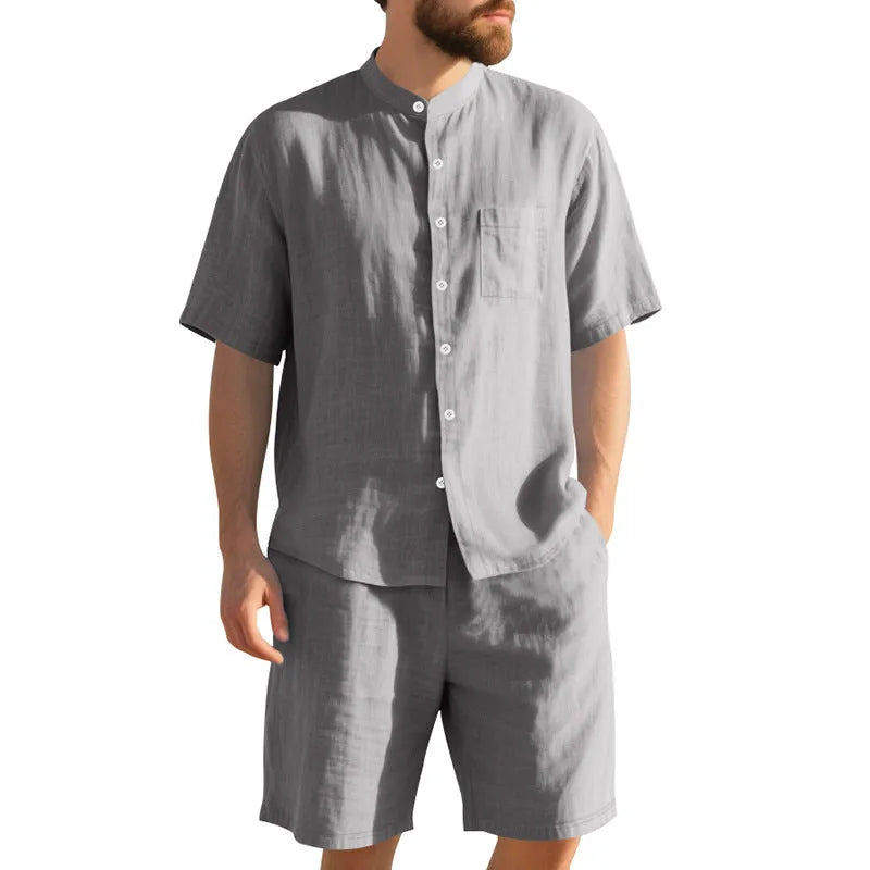 Men's light blue linen two-piece suit with Henry collar, short sleeves, and matching shorts for summer wear
