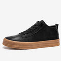 Men's black leather casual shoes with round toe, flat heel, and white laces on a rubber sole.