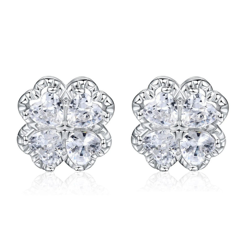 Close-up of women's 925 silver drop earrings with a four-leaf clover charm and heart zircon, in white gold colour.