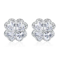Close-up of women's 925 silver drop earrings with a four-leaf clover charm and heart zircon, in white gold colour.