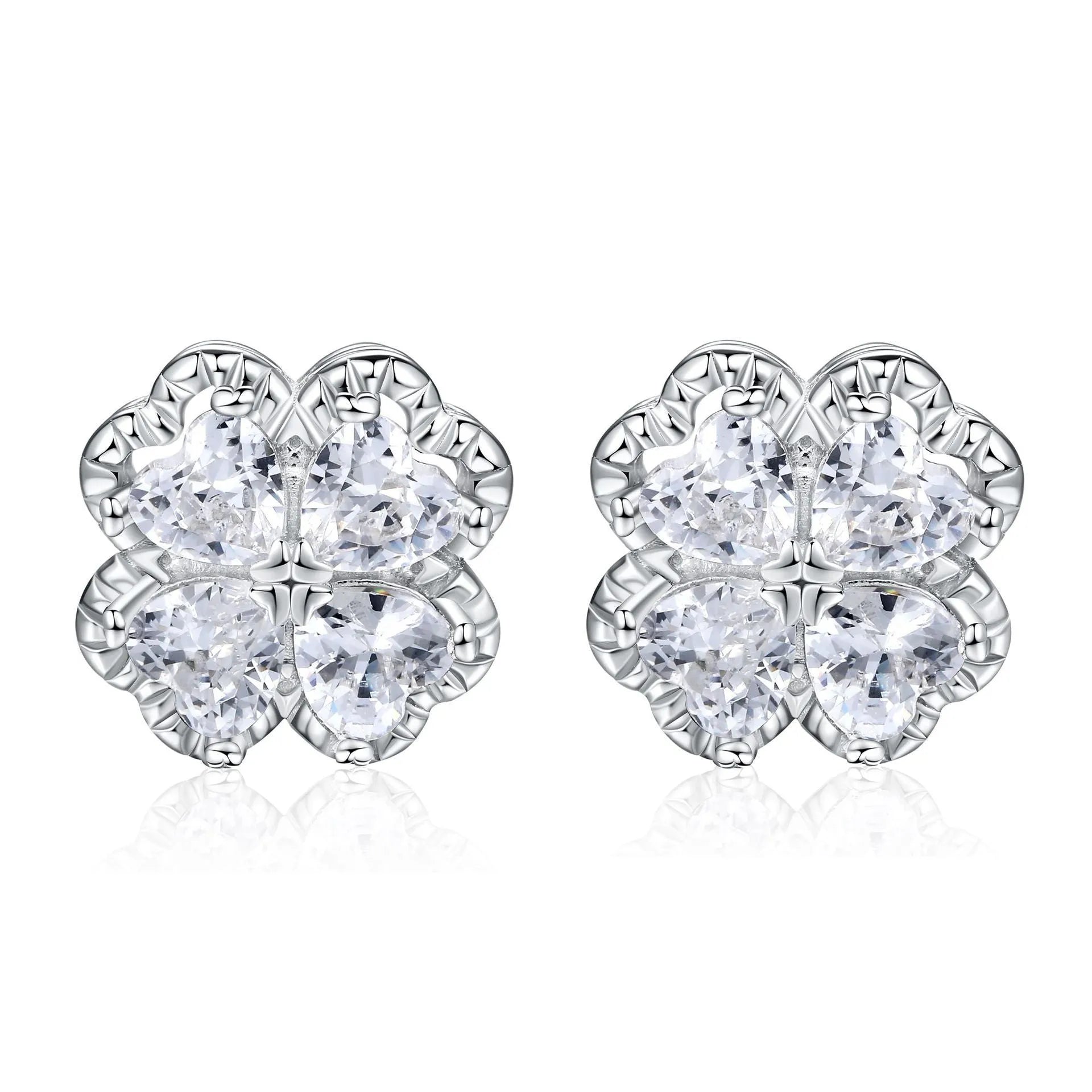 Close-up of women's 925 silver drop earrings with a four-leaf clover charm and heart zircon, in white gold colour.