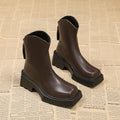 Black square toe women's platform Martin boots with a high heel and back zipper.