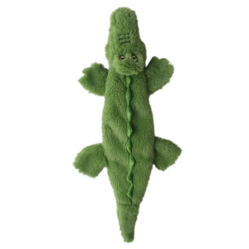 Green plush crocodile dog toy with no stuffing, featuring a squeaker head and crinkle paper tail.
