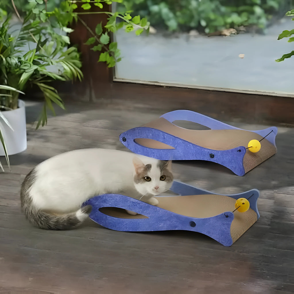 Blue fish-shaped cat scratcher with corrugated cardboard construction and hanging bell ball toy