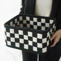 Checkerboard patterned foldable felt storage basket showing its woven texture and open-top design.