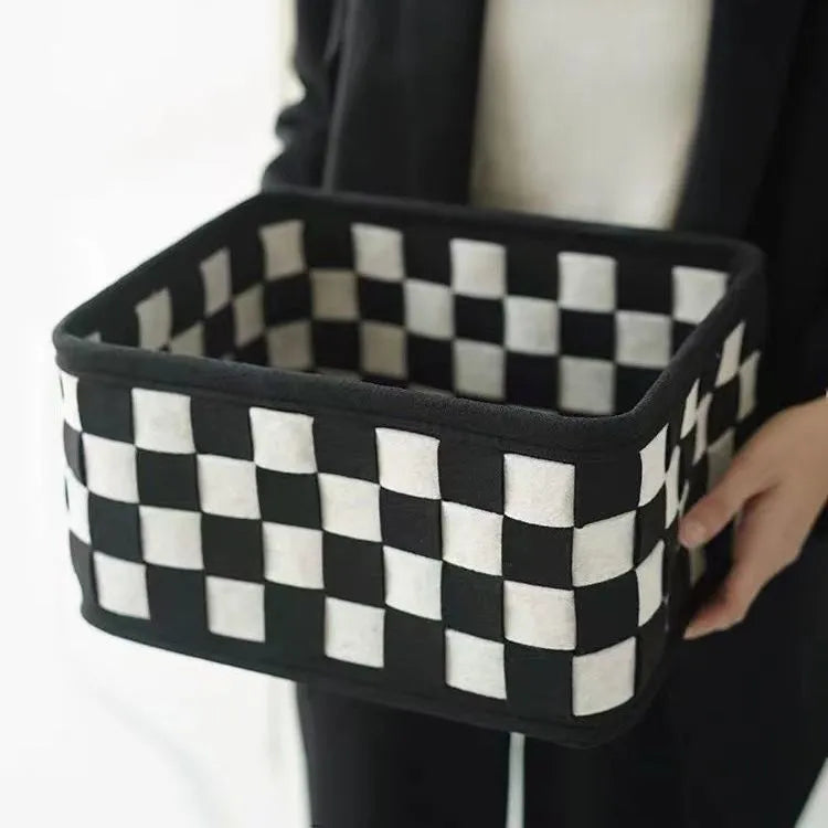 Checkerboard patterned foldable felt storage basket showing its woven texture and open-top design.