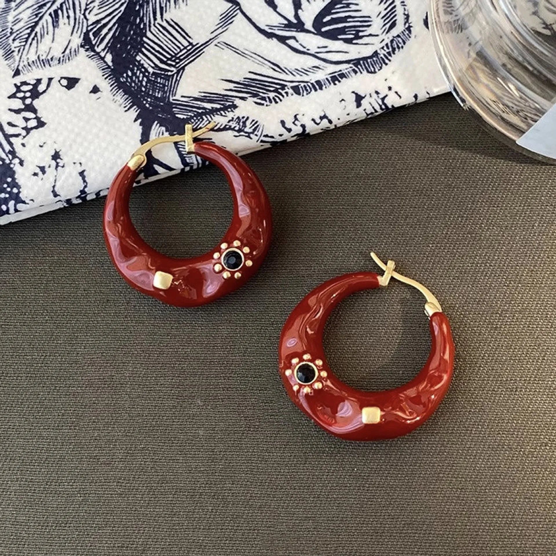 Hong Kong style retro ear studs with dripping oil finish and rhinestone accents in black and red colours