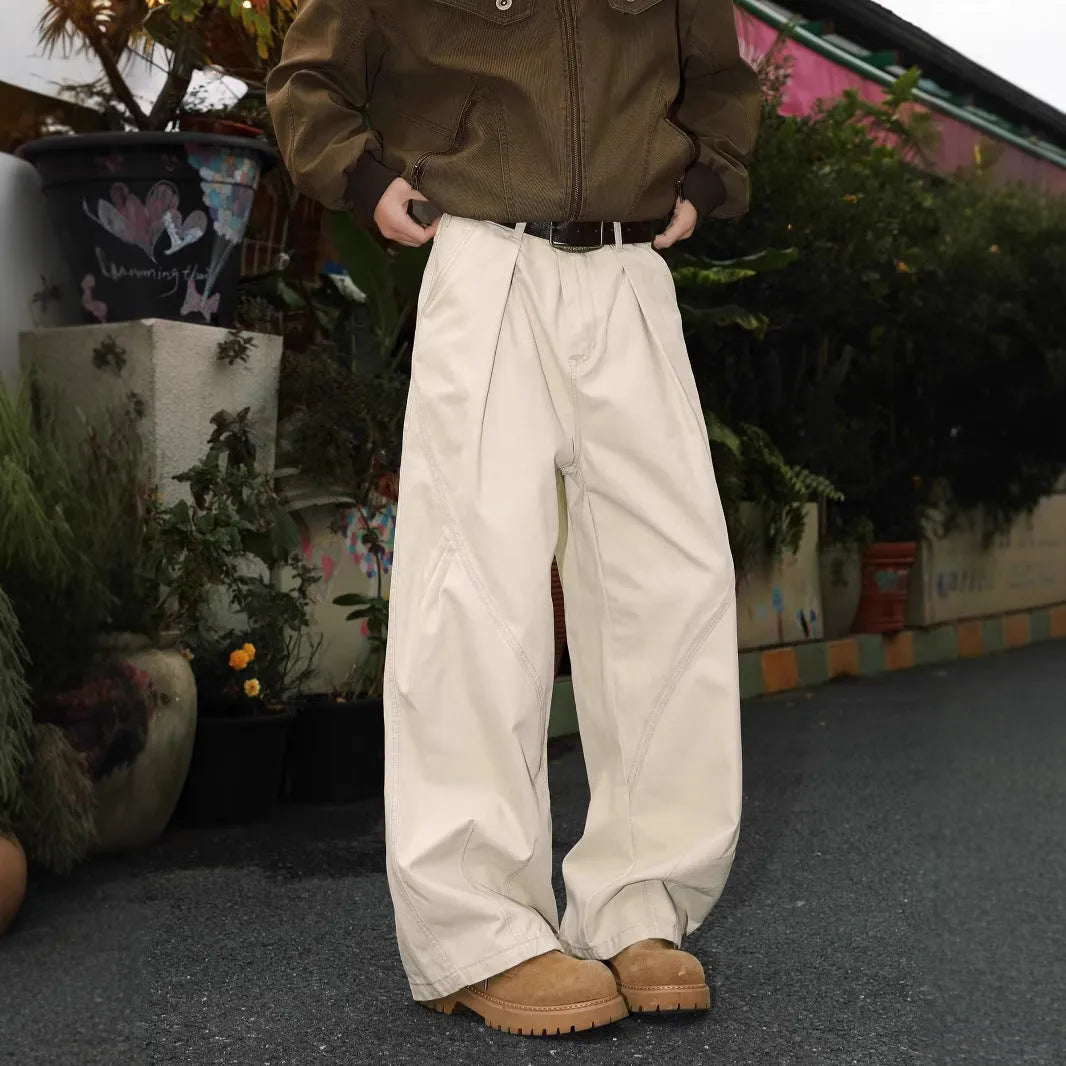 Men's pleated straight leg loose fit trousers in a black stripe pattern, showing front and side details.