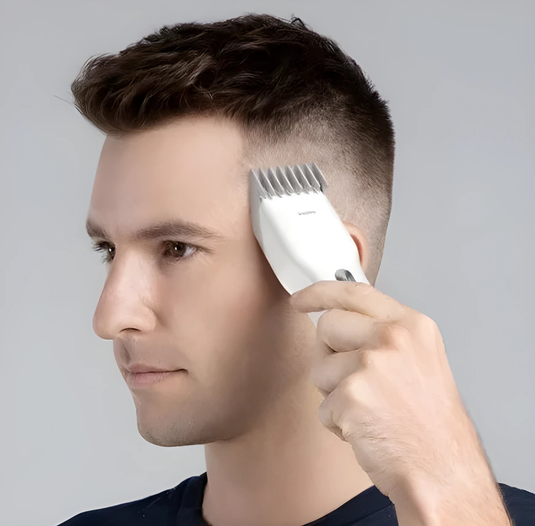 Black and white cordless hair clipper with adjustable comb and ceramic cutter head on a plain background
