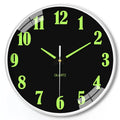 Modern 8 inch diameter luminous wall clock with plastic shell on a wall.
