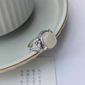 Copper vintage ring with imitation white chalcedony stone and adjustable U-shaped open design.