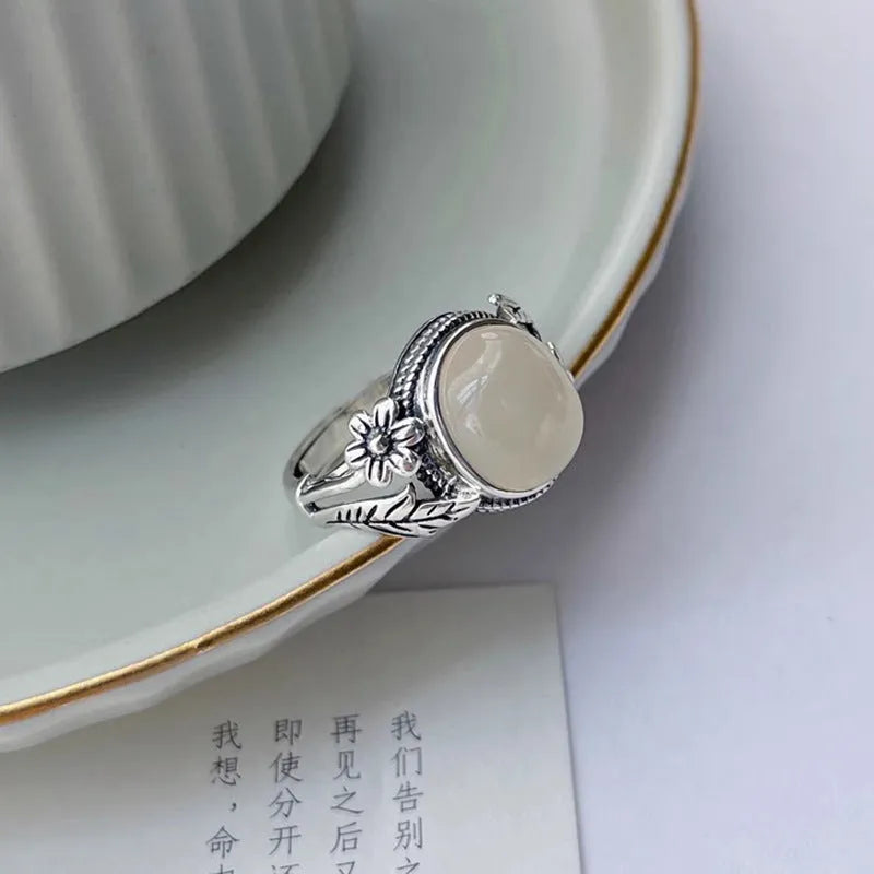 Copper vintage ring with imitation white chalcedony stone and adjustable U-shaped open design.