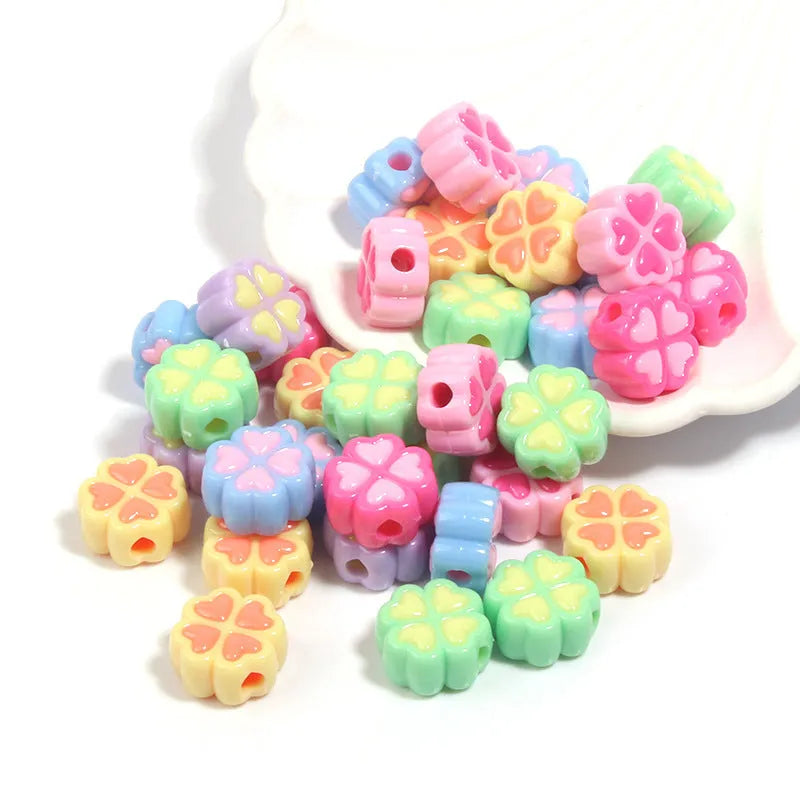 Assortment of 15mm frosted acrylic four-leaf clover beads in pink, yellow, green, blue, purple, and rose red.