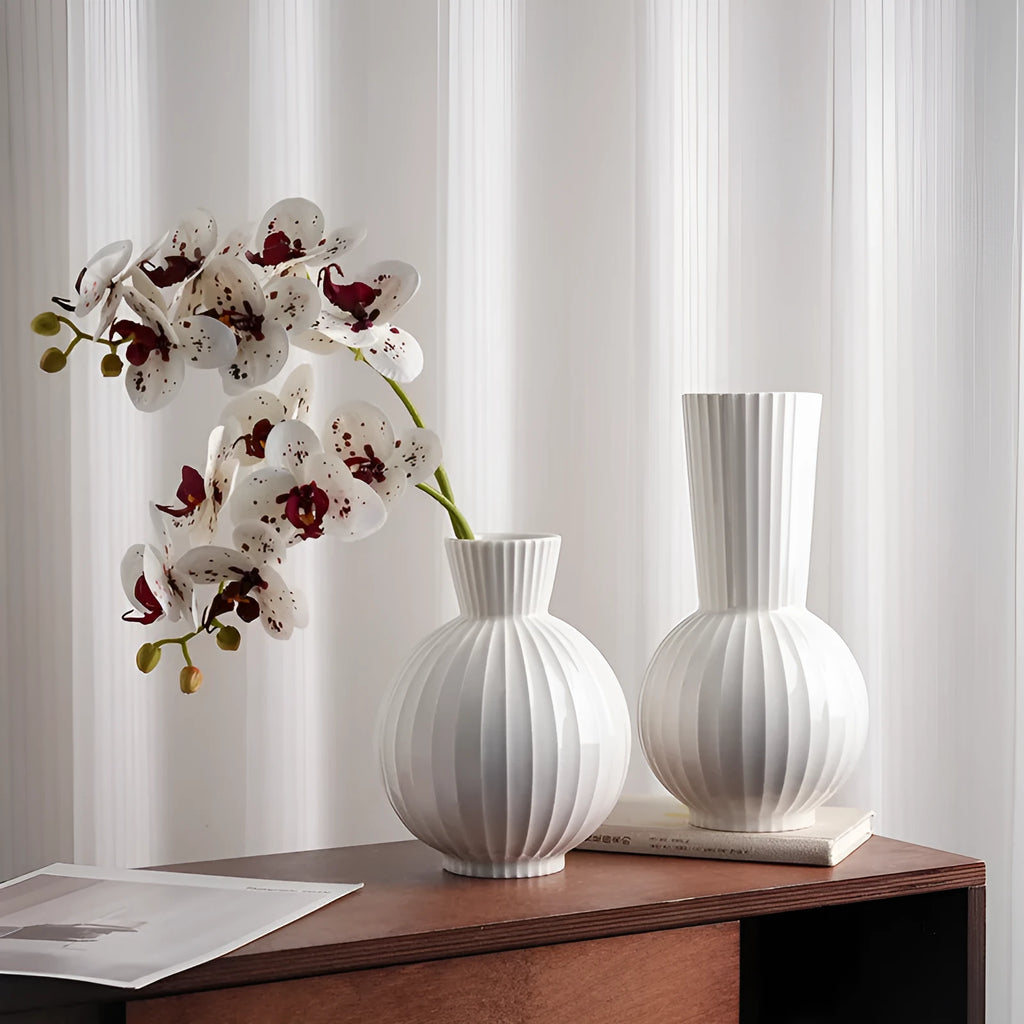 White ceramic ball vase with stripes, American country style, shown on a table.