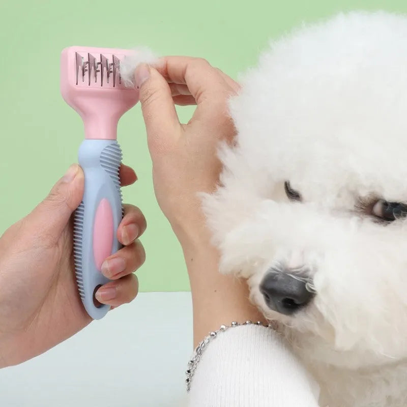 Pink stainless steel dog comb with built-in knot knife and massage teeth for pet grooming.