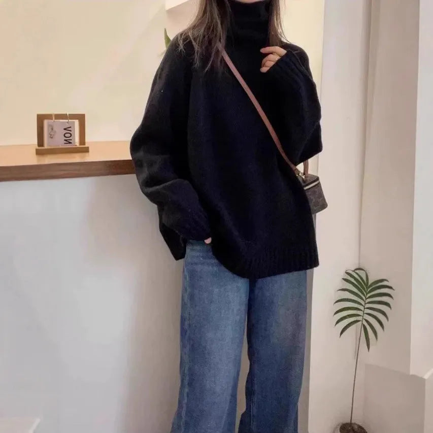 Women's loose turtleneck sweater with thick curling pile collar in red, camel, grey, or black.