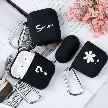 Black and pink AirPods case covers with smiley face and flower decorative motifs