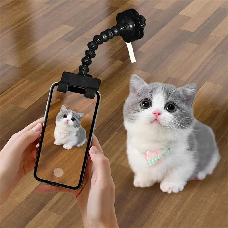 Pet photography selfie stick with clip for snacks in black plastic, showing phone holder and rotatable head