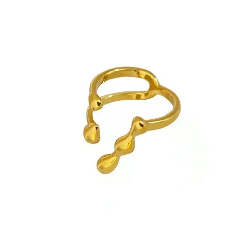 Brass opening ring with spherical element in gold finish on model finger