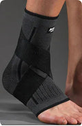 Sports ankle support in black, green or orange with adjustable compression strap