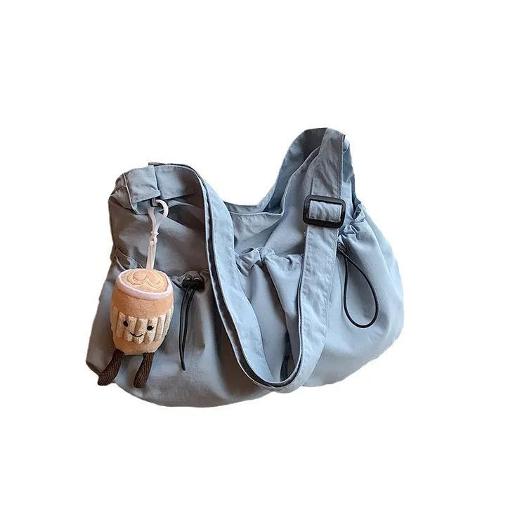 Green ultra-light pleated crossbody bag made of soft polyester fabric with a folding design.