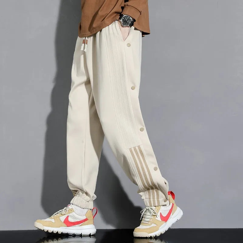 Men's black loose sports sweatpants with ankle ties and elastic high waist