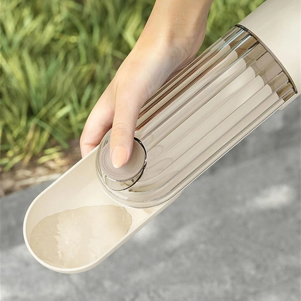 Beige foldable dog water bottle with food dispenser showing collapsible design and drinking tray