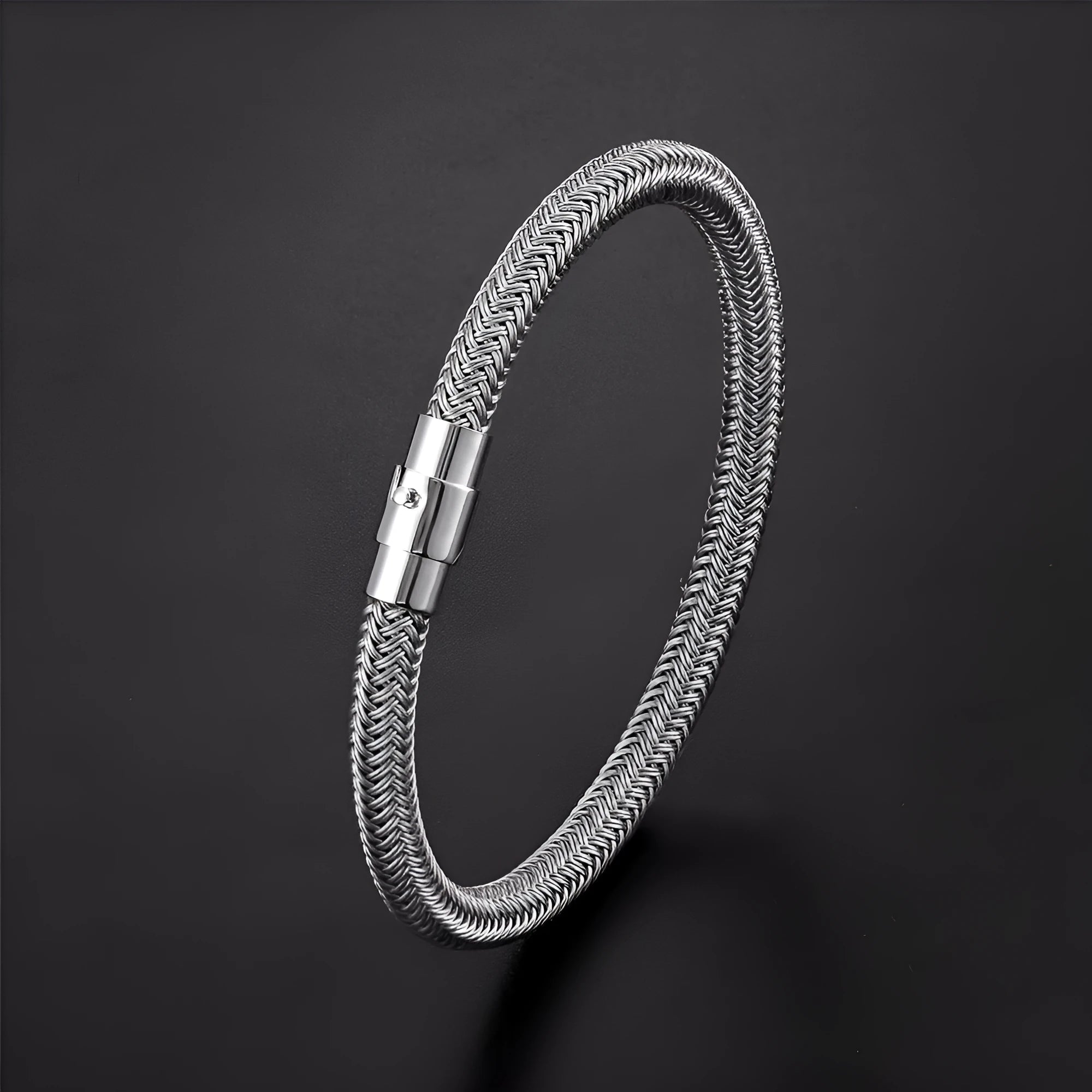 Titanium steel geometric wire bracelet with magnet socket closure in silver tone.