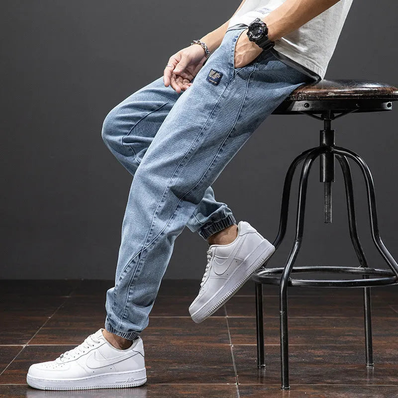 Men's straight leg cargo jeans in blue, showing loose fit, cargo pockets, and mid waist design.