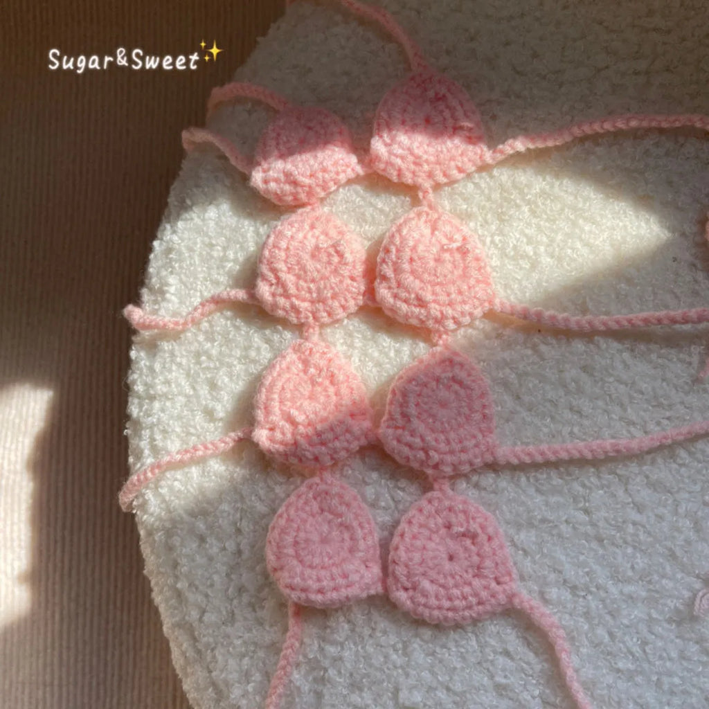Cat wearing a pink bikini costume with bra top and matching bottom for Halloween