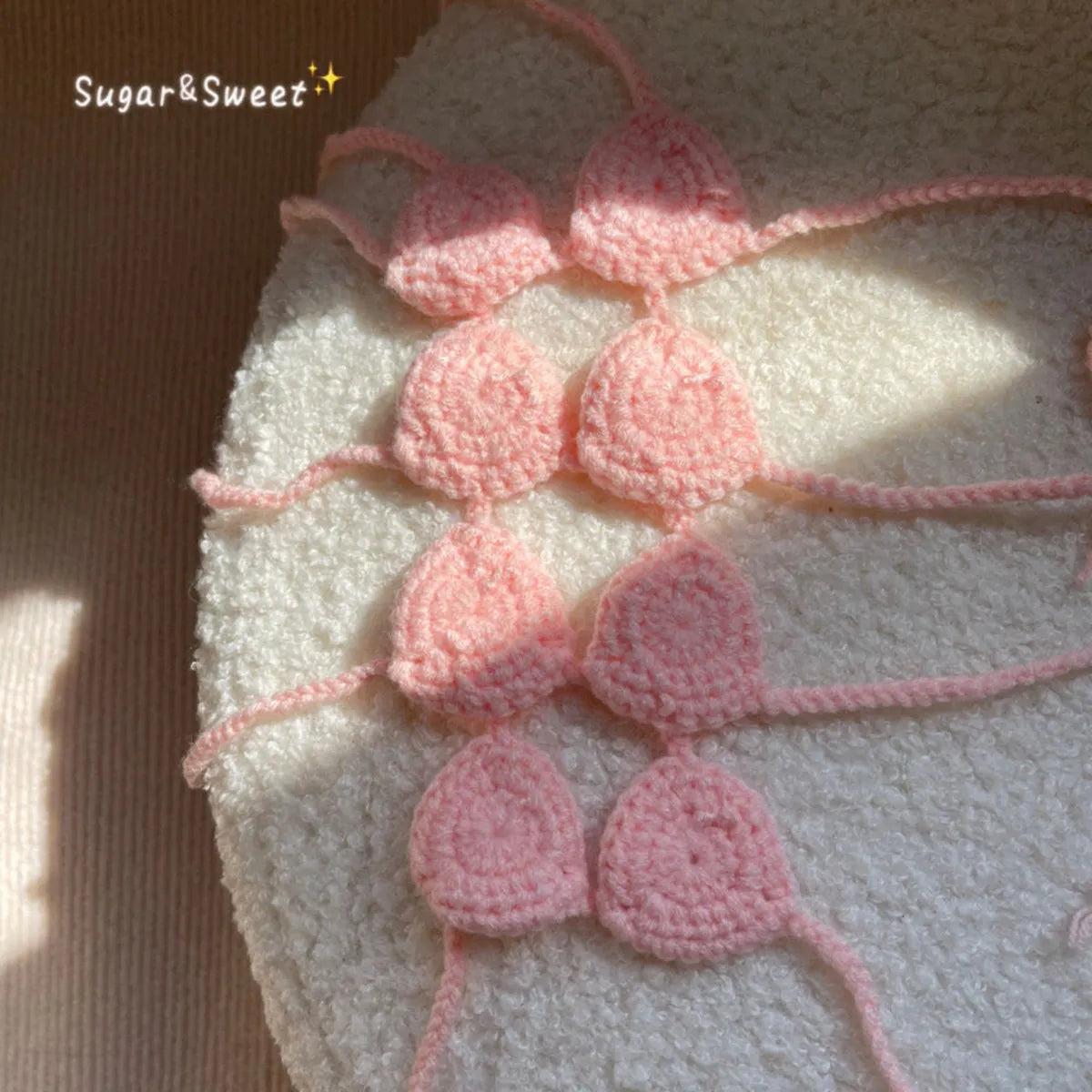 Cat wearing a pink bikini costume with bra top and matching bottom for Halloween