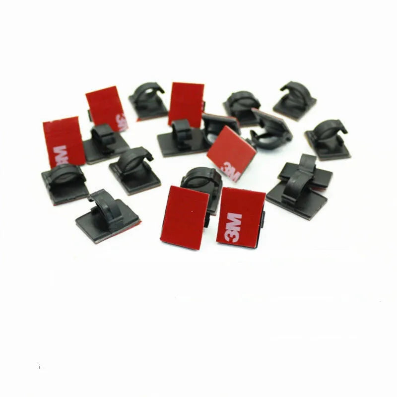 Black self-adhesive flat cable wiring buckle for car wire management on a surface