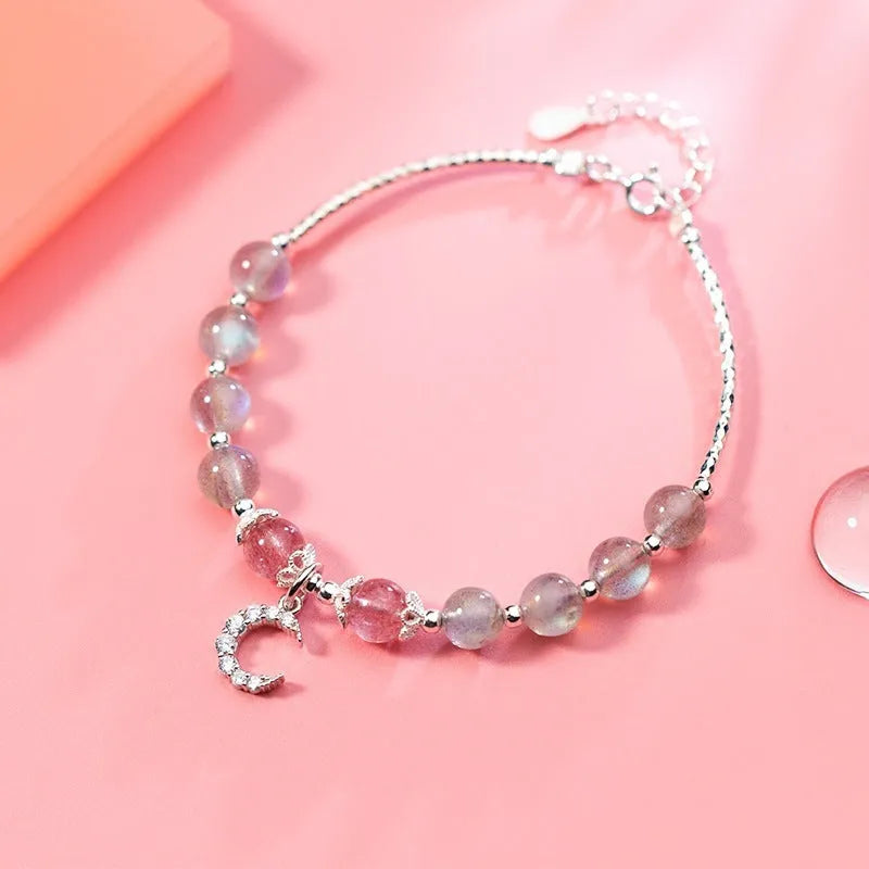 Natural moonstone adjustable bracelet with crescent moon charm and crystal accent on wrist