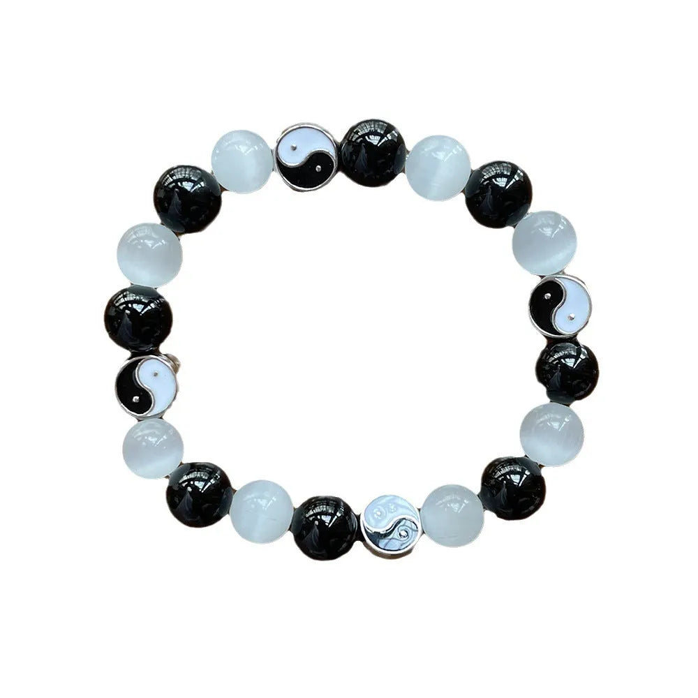 Natural stone opal agate Tai Chi bracelet with 10mm polished beads and black agate detail, unisex design on neutral background