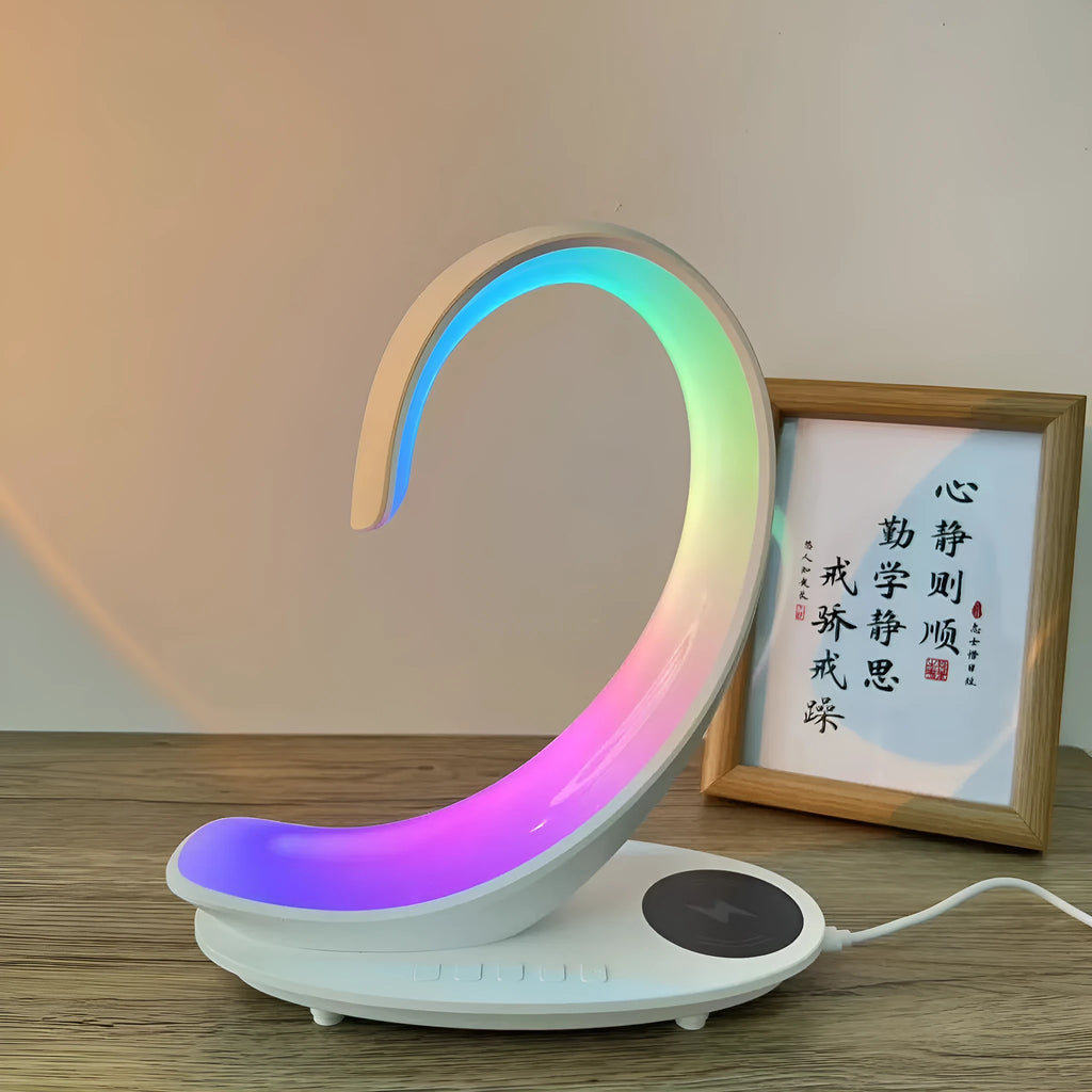 White swan-shaped desktop device with wireless charging surface, Bluetooth speaker, and colourful atmosphere lighting