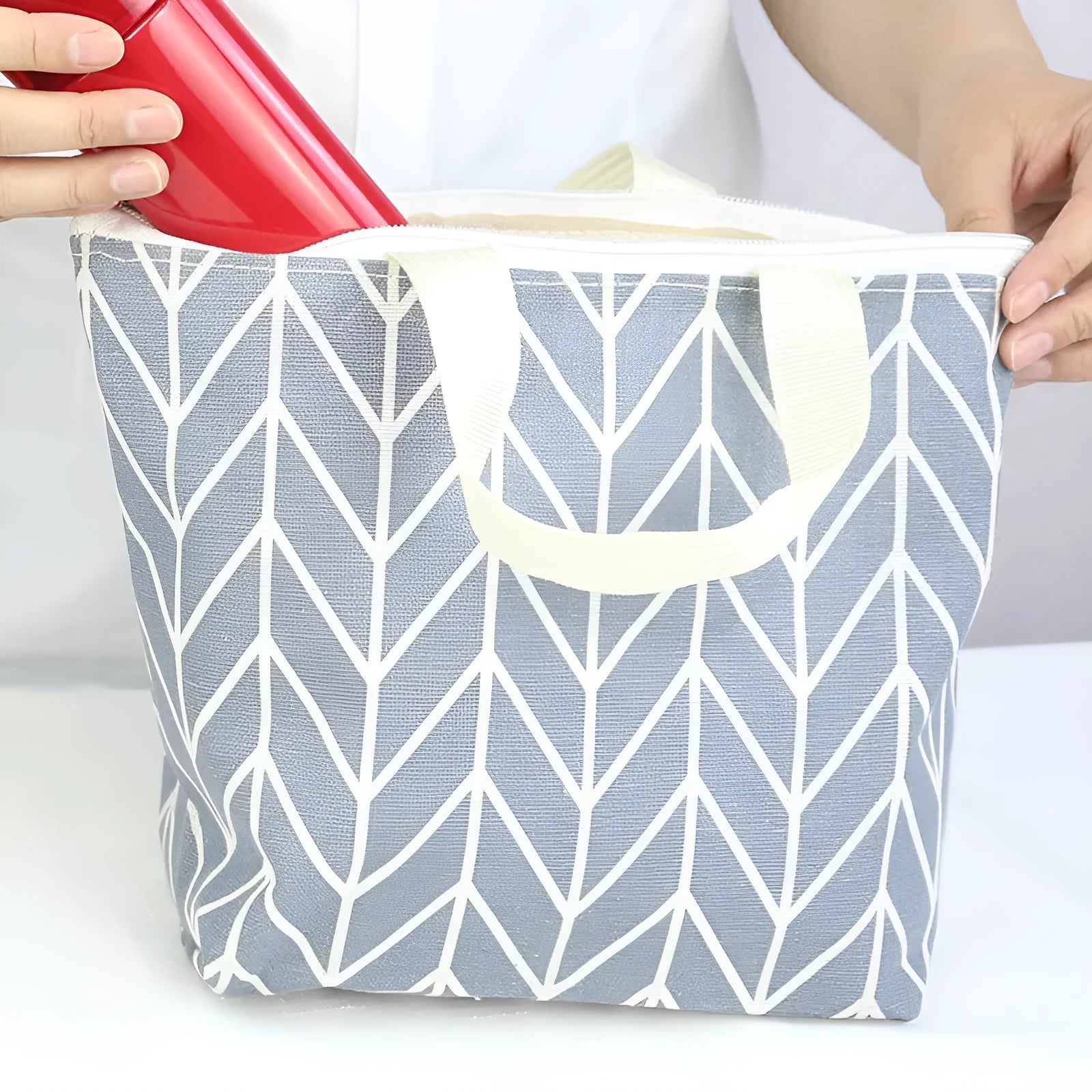 Arrow pattern polyester makeup bag with black zip closure.