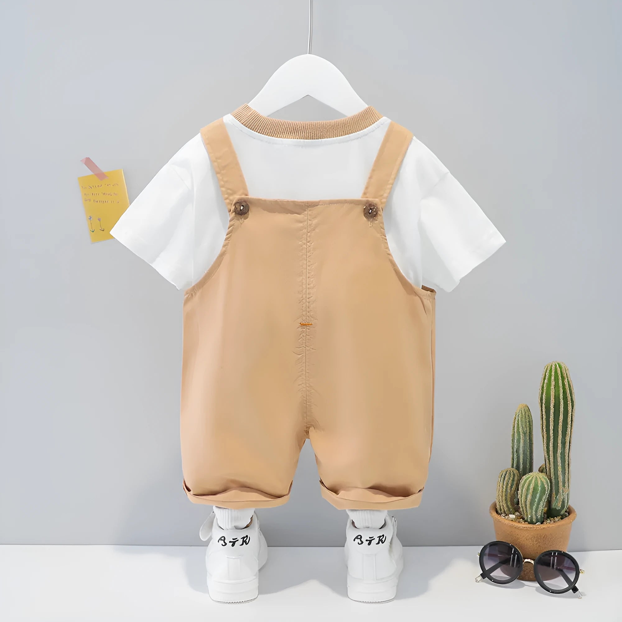 Cotton baby cartoon overalls in khaki with adjustable straps, shown on size chart for 70cm to 110cm.