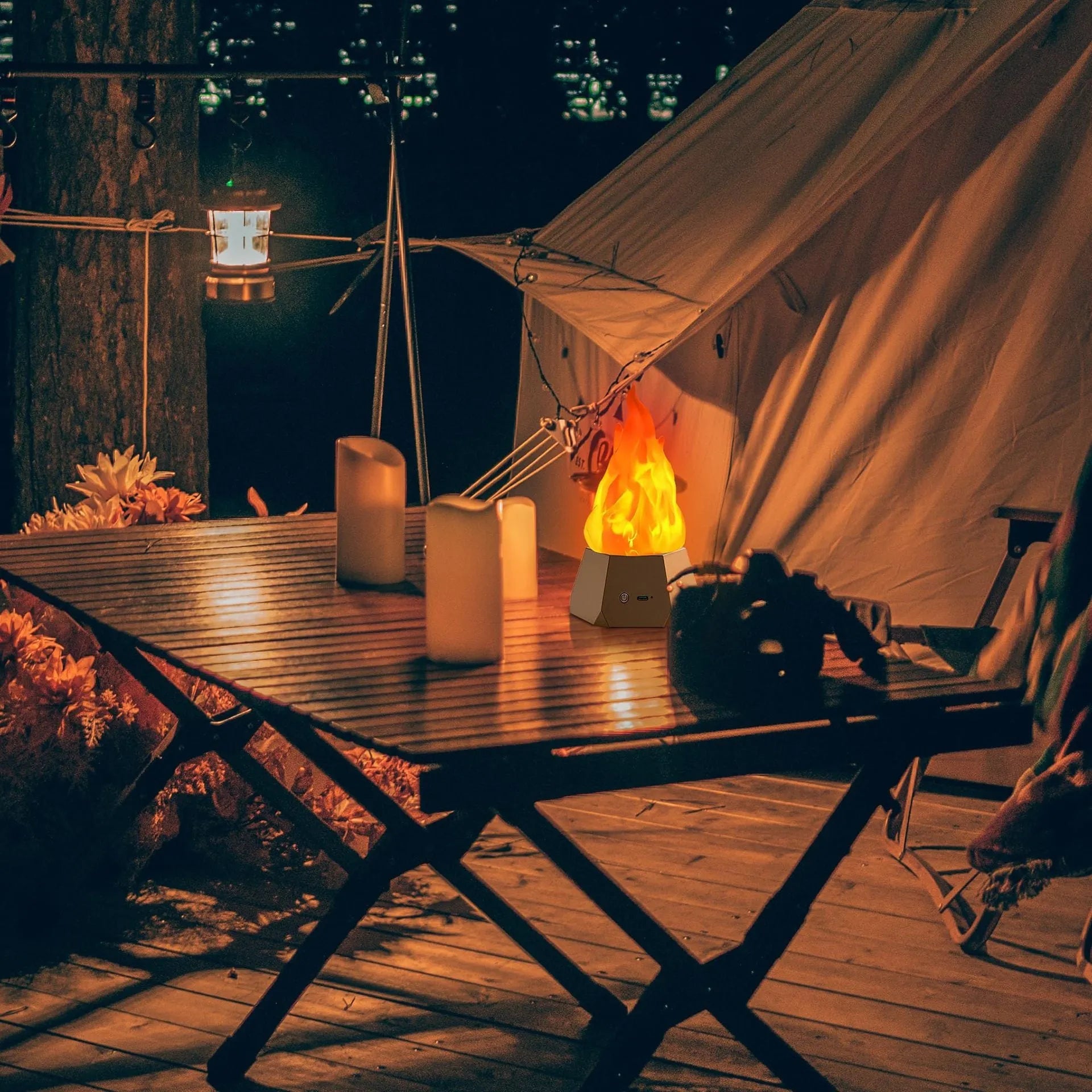 Flame-shaped outdoor decorative light with vinyl shell and gold charging base on a garden table
