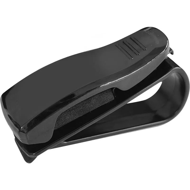 Black plastic multifunctional clip for car sun visors, designed to hold sunglasses and cards.