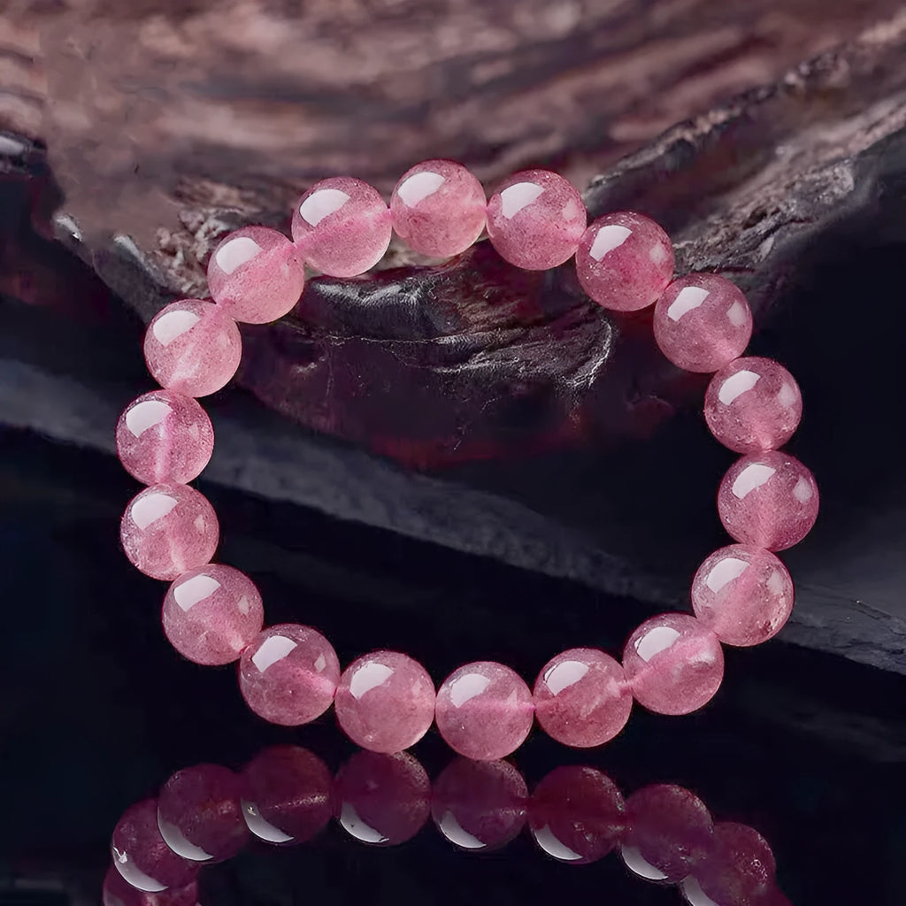 Women's adjustable bracelet with mixed-size polished strawberry quartz crystal beads.
