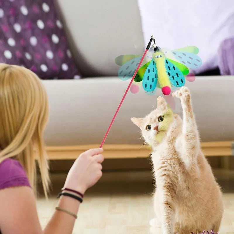 Cat wand toy with bell dragonfly attachment in green, yellow, and pink on white background