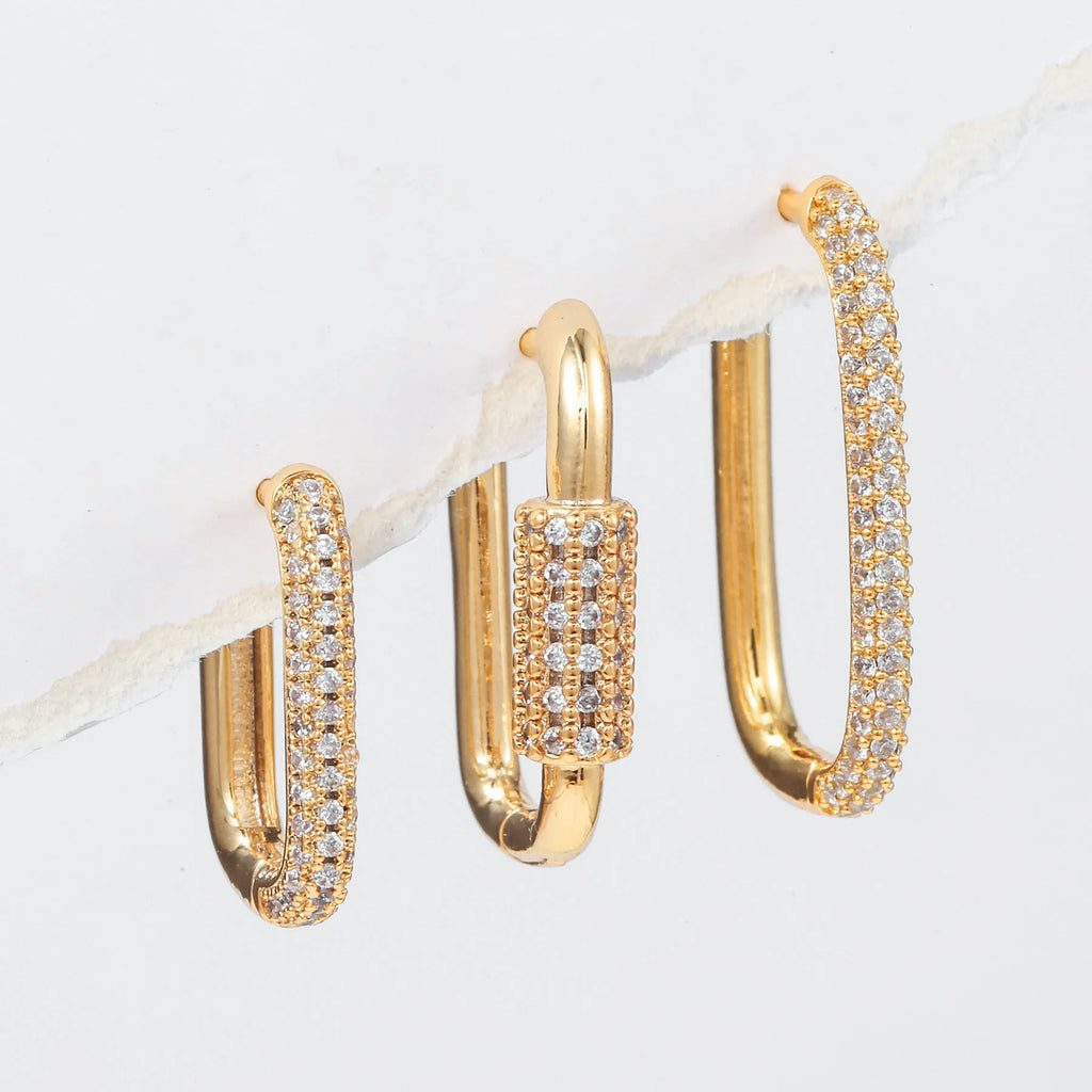 Three geometric ear clips with micro inlaid zircon detailing on copper in gold and white colours